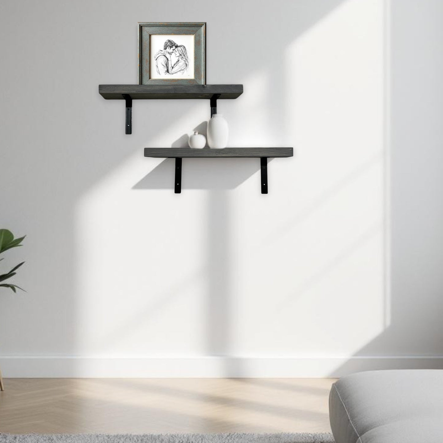 Modern living room with a white sofa, wall-mounted shelves, and a framed picture.