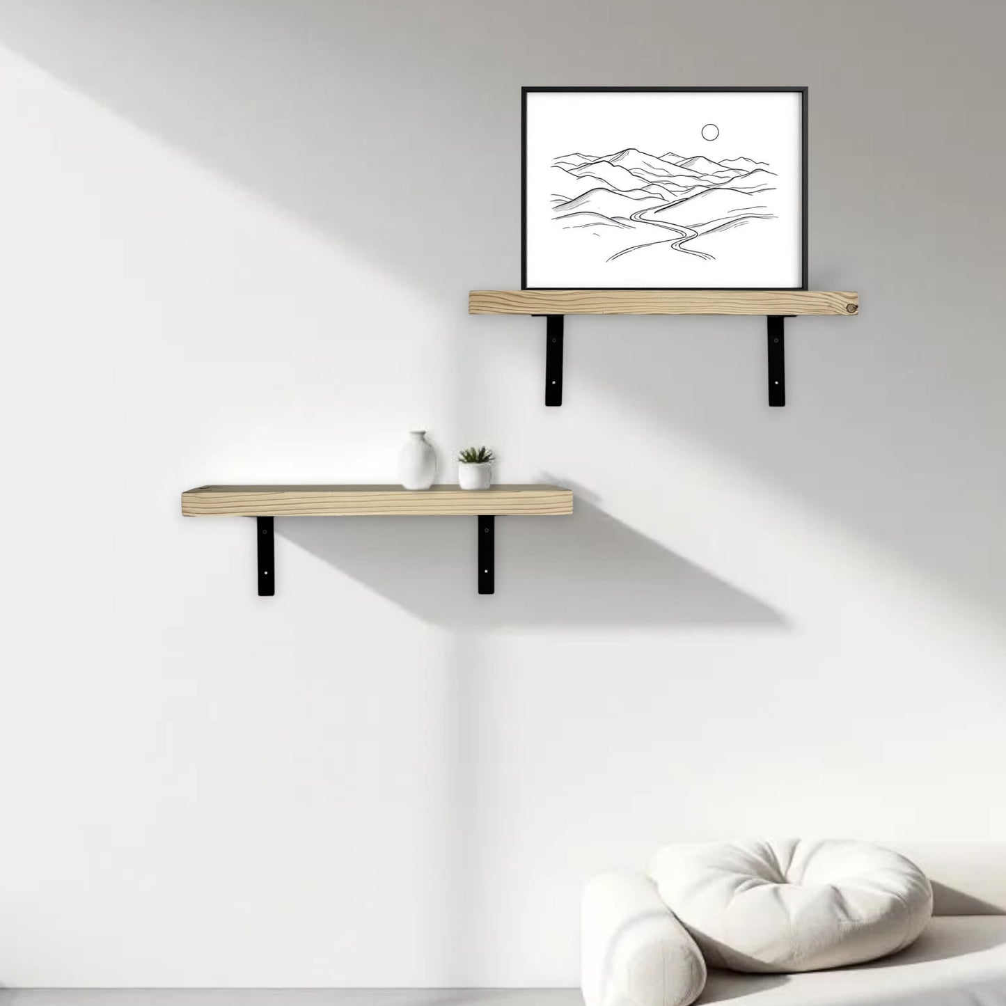 Two wooden shelves on a white wall with a framed black and white abstract art piece.