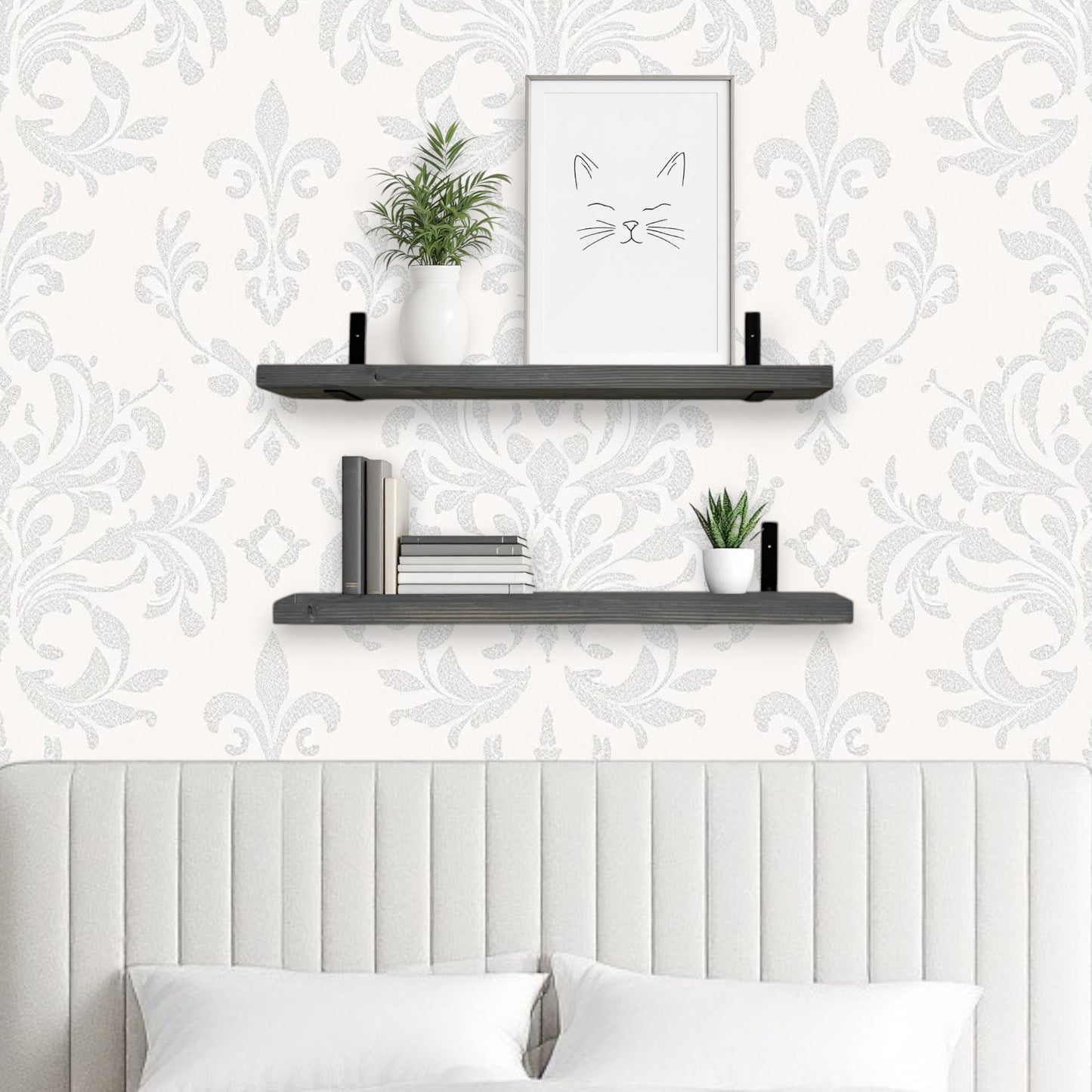 Decorative wall shelves with plants and a framed picture against a patterned wallpaper.