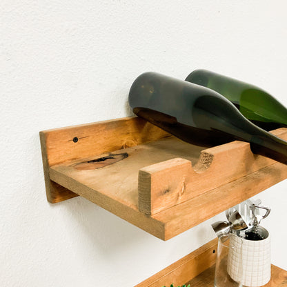 Handmade solid wood wall-mounted wine rack in dark walnut with floating shelf design, modern rustic furniture style.