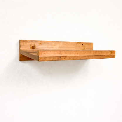 Rustic gray solid wood floating wall shelf with integrated hanging wine glass rack, handmade furniture.