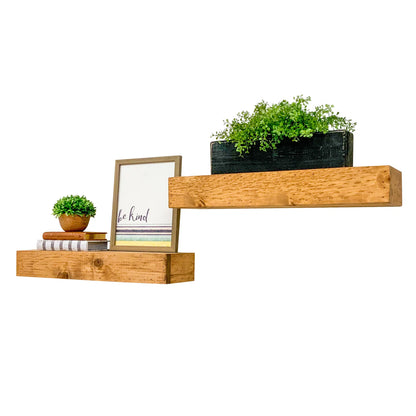 Dark walnut solid wood floating box shelves mounted above white sofa in modern rustic living room.