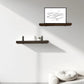 Modern interior with wooden shelves and a framed picture on a white wall.