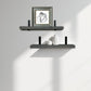 Two floating shelves with decorative items against a plain wall