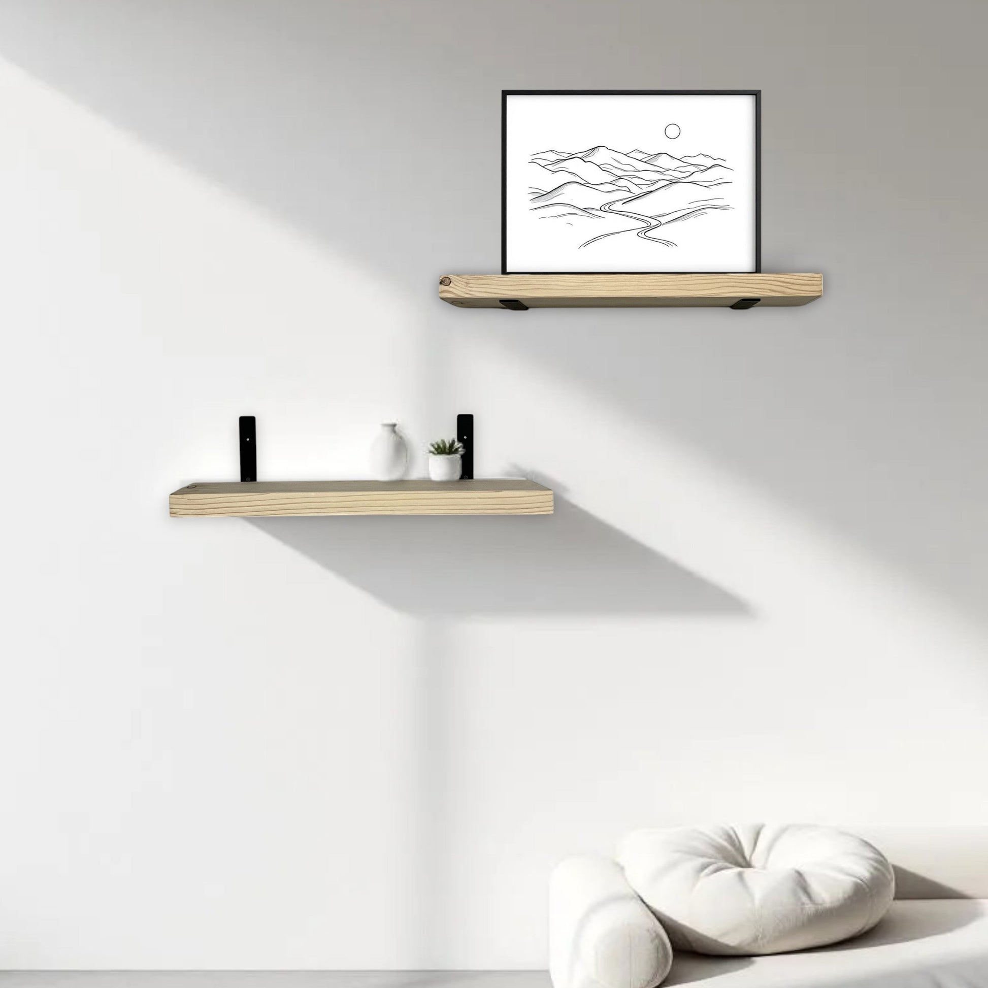 Two wooden shelves on a white wall with a framed picture and decorative items.