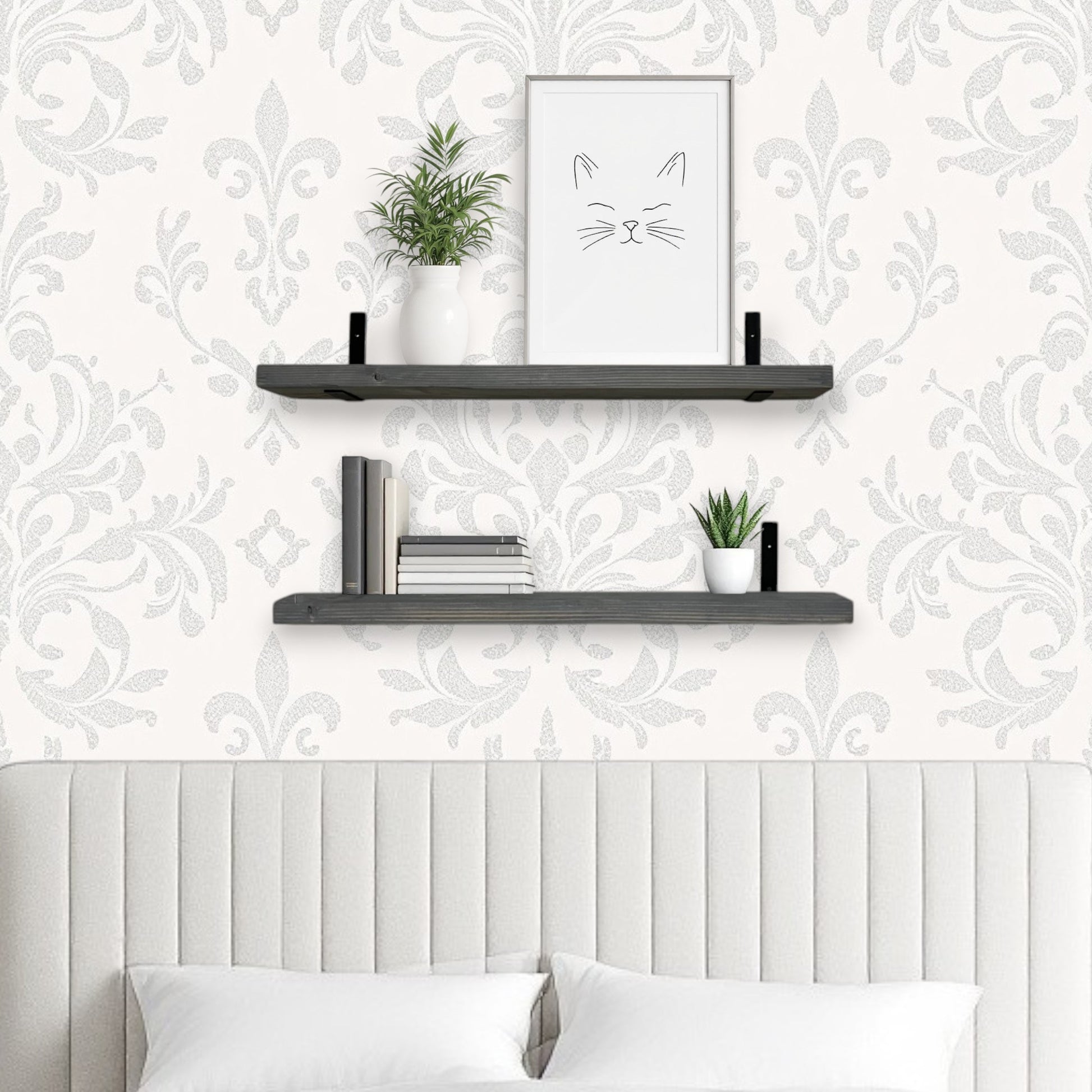 Decorative wall shelves with plants and a framed picture against a patterned wallpaper.