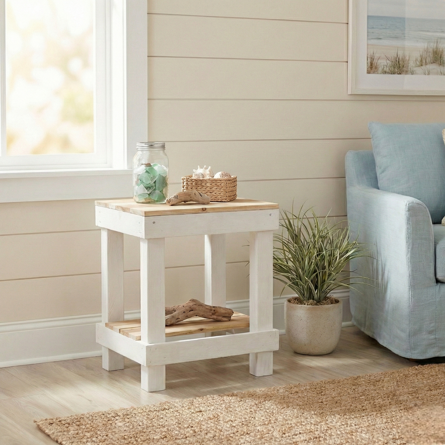 Rustic farmhouse solid wood handmade end table with open shelves and natural finish next to gray sofa.
