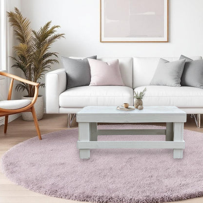 White solid wood coffee table with a plank top in modern rustic furniture style.