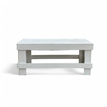 White solid wood coffee table with a plank top in modern rustic furniture style.